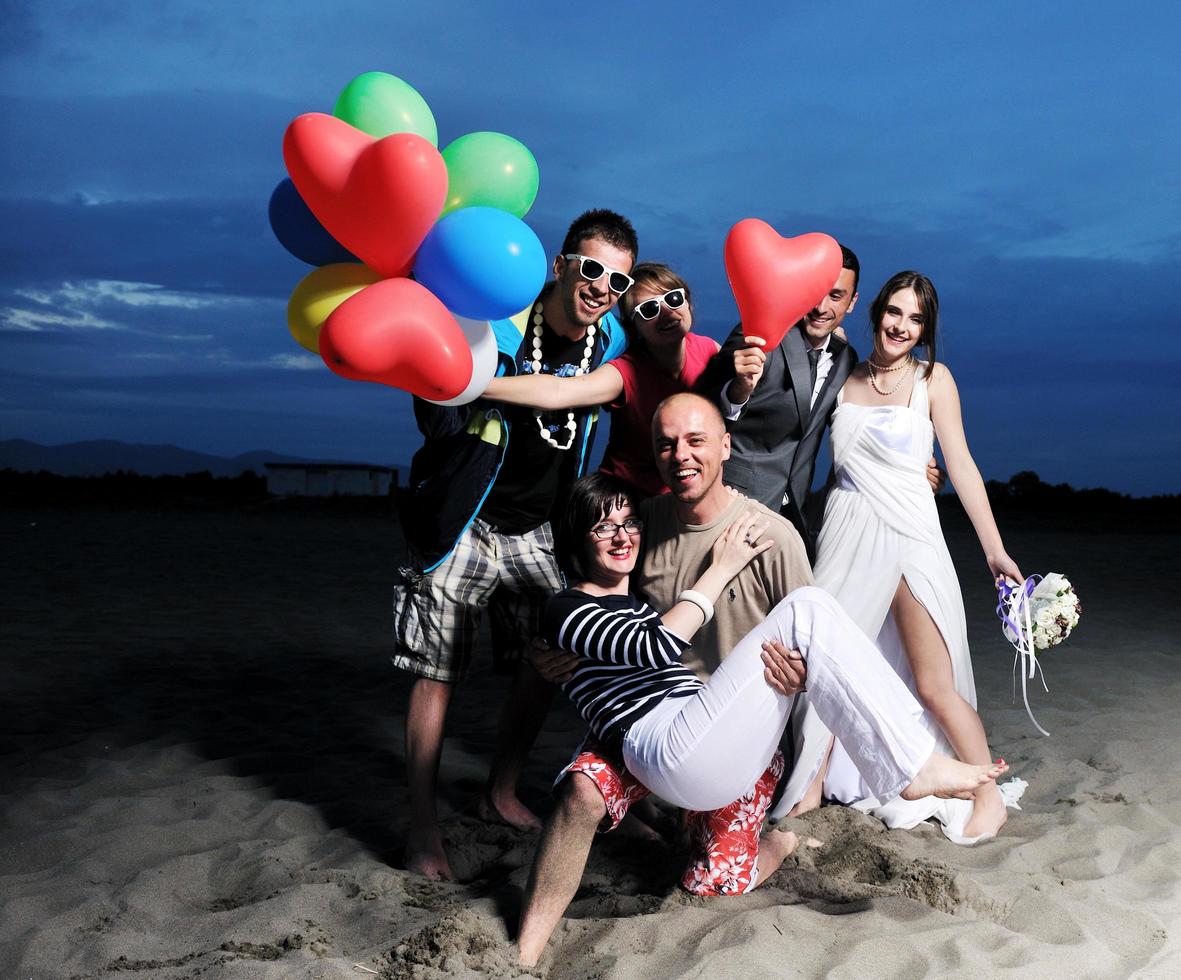 happy young  people group have fun on beach photo