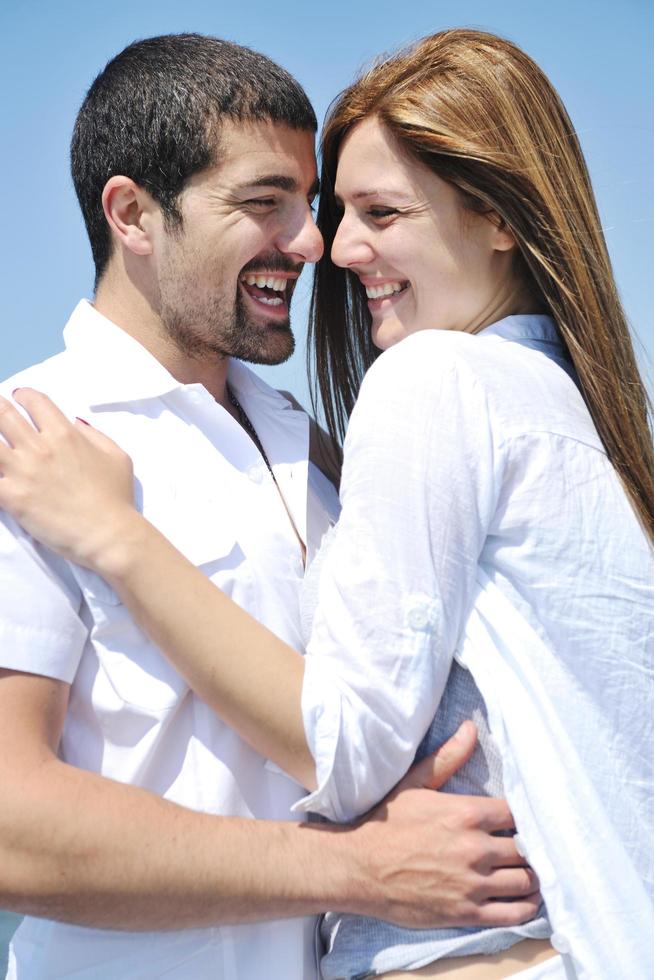 happy young couple have fun on beach photo