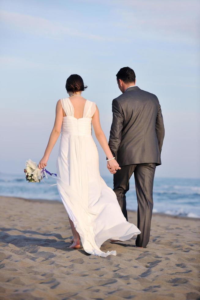 romantic beach wedding at sunset photo