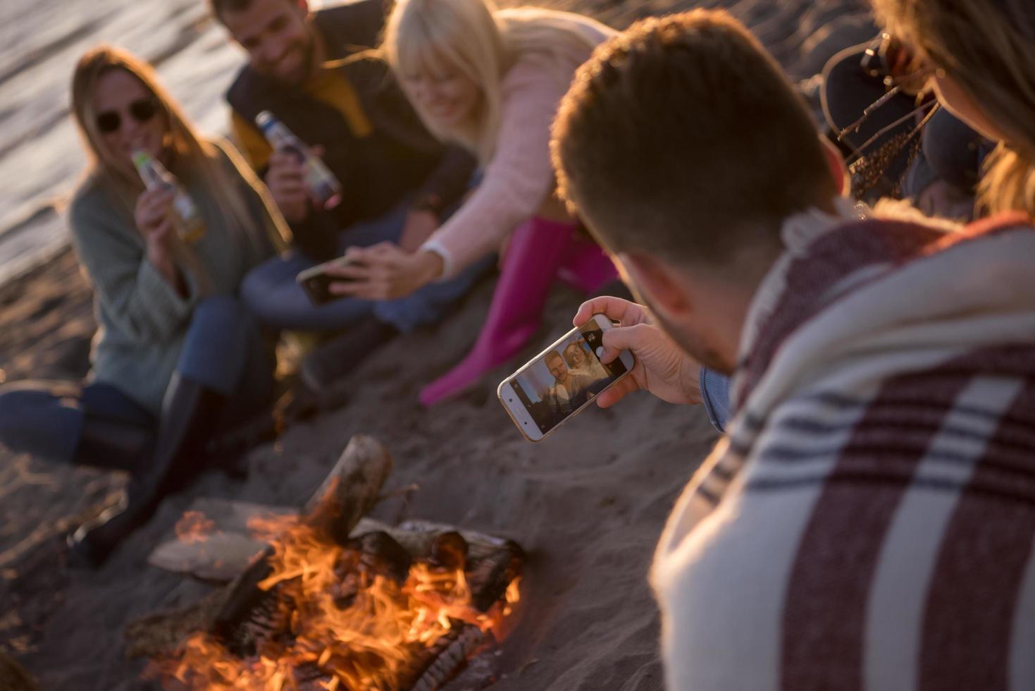 Friends having fun at beach on autumn day photo