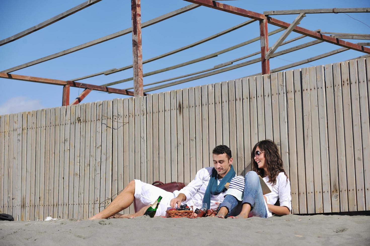 young couple enjoying  picnic on the beach photo