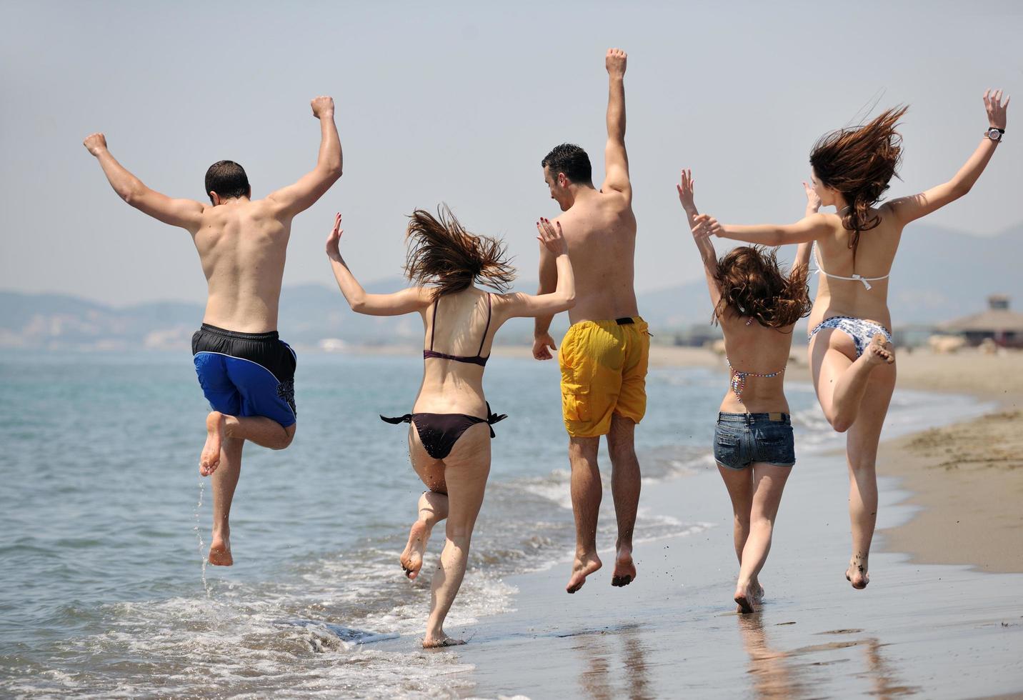 happy young  people group have fun on beach photo