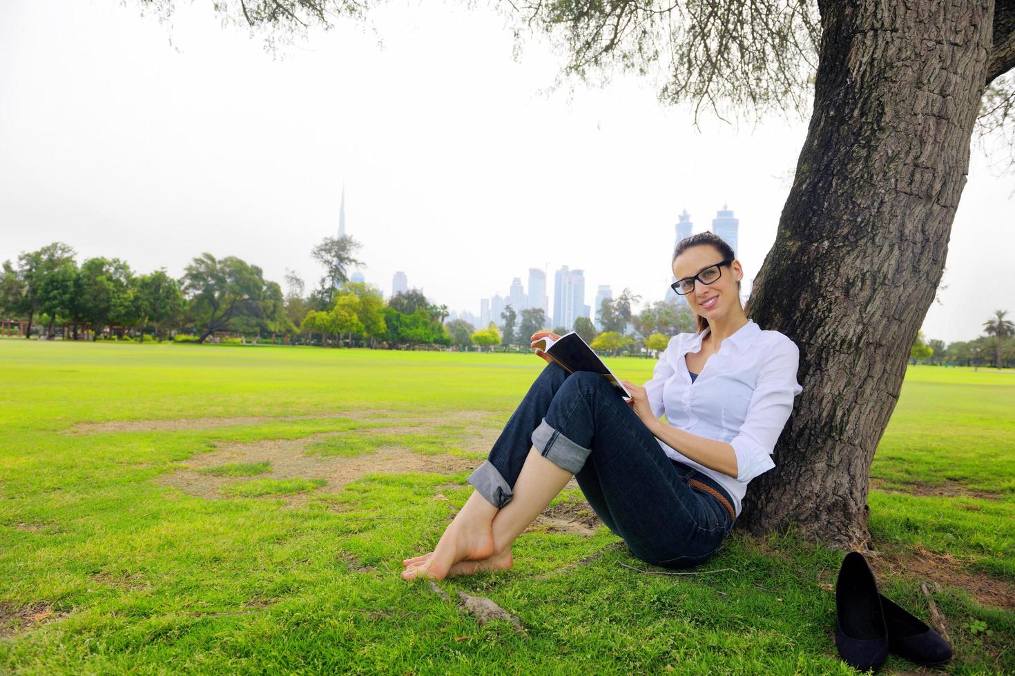 Young woman reading a book in the park photo