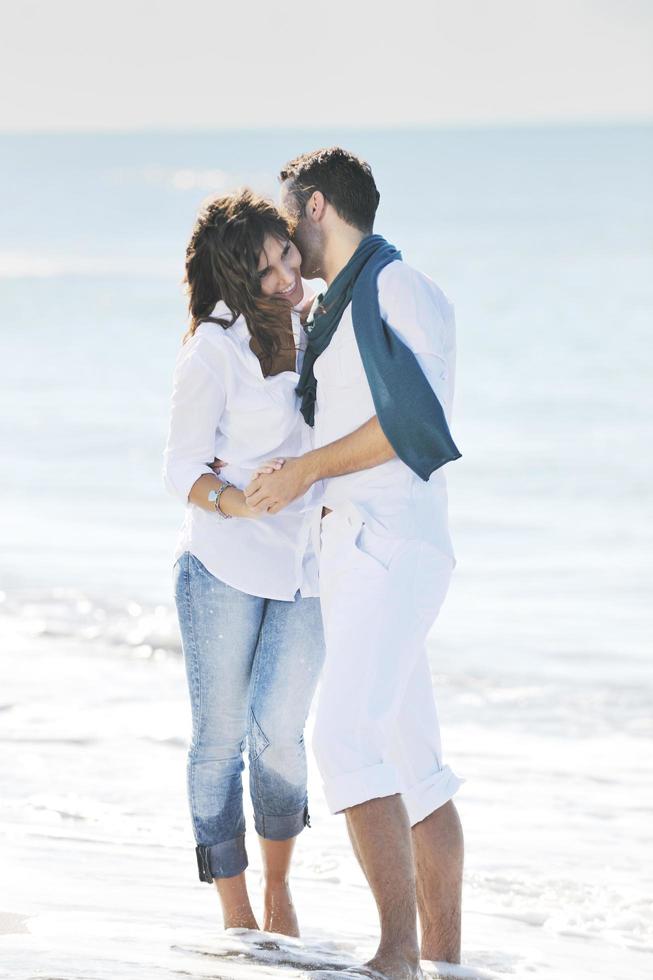 happy young couple have fun at beautiful beach photo