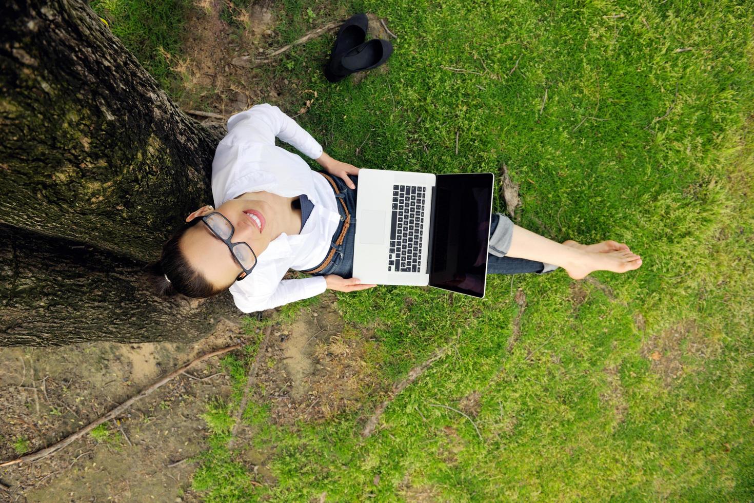 woman with laptop in park photo