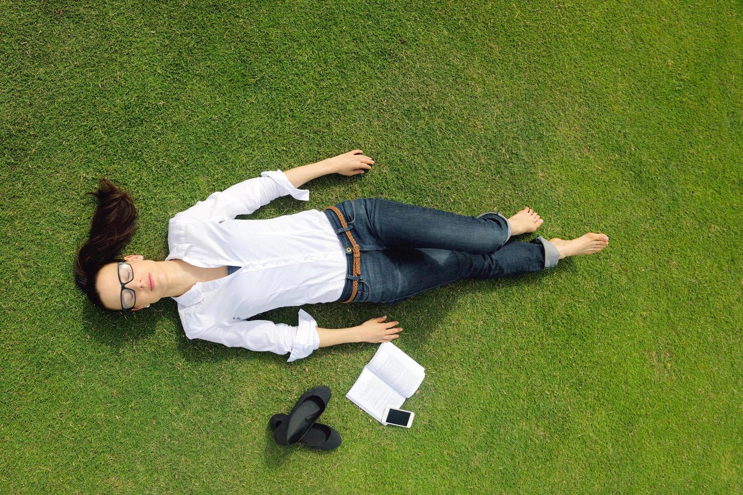 Young woman reading a book in the park photo