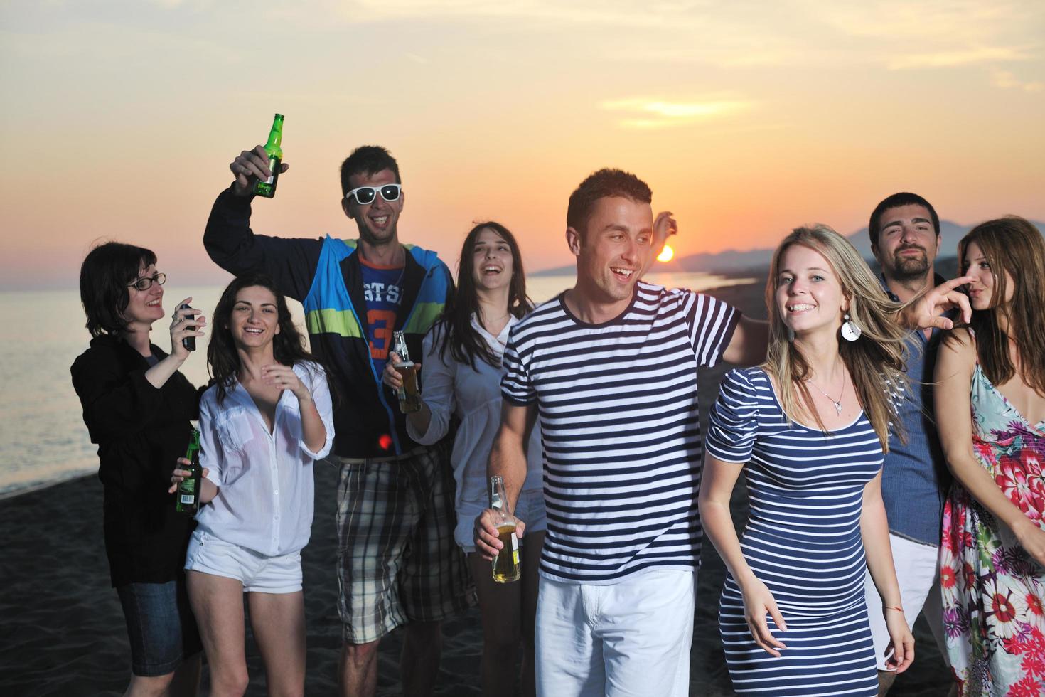 Group of young people enjoy summer  party at the beach photo