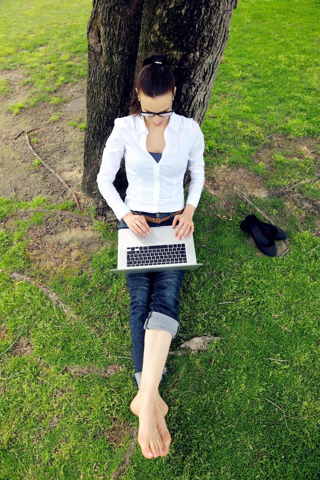 woman with laptop in park photo