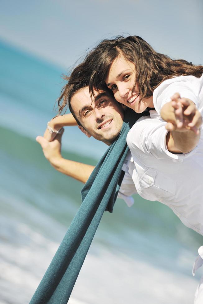 happy young couple have fun at beautiful beach photo