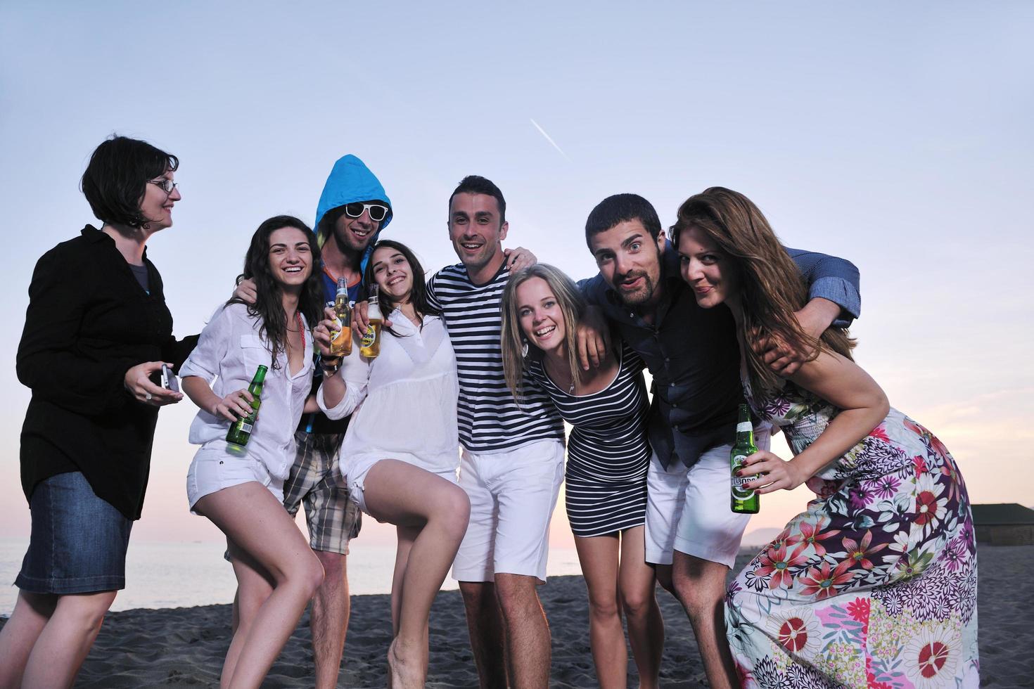 Group of young people enjoy summer  party at the beach photo