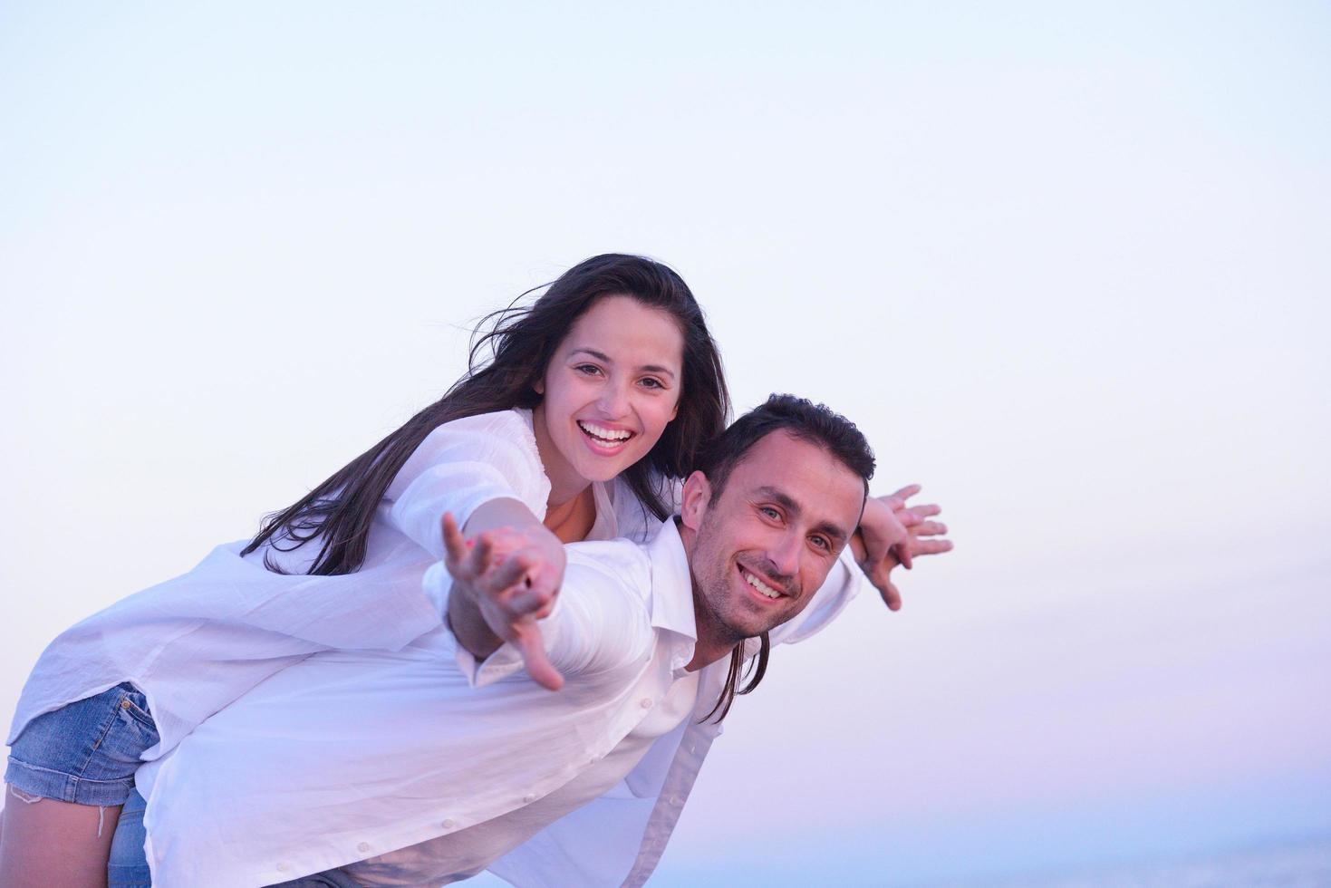 young couple  on beach have fun photo