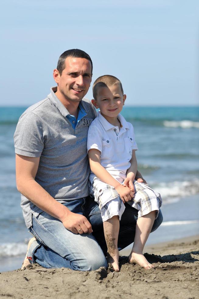 happy father and son have fun and enjoy time on beach photo