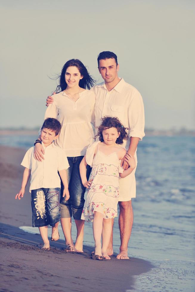 happy young family have fun on beach at sunset photo
