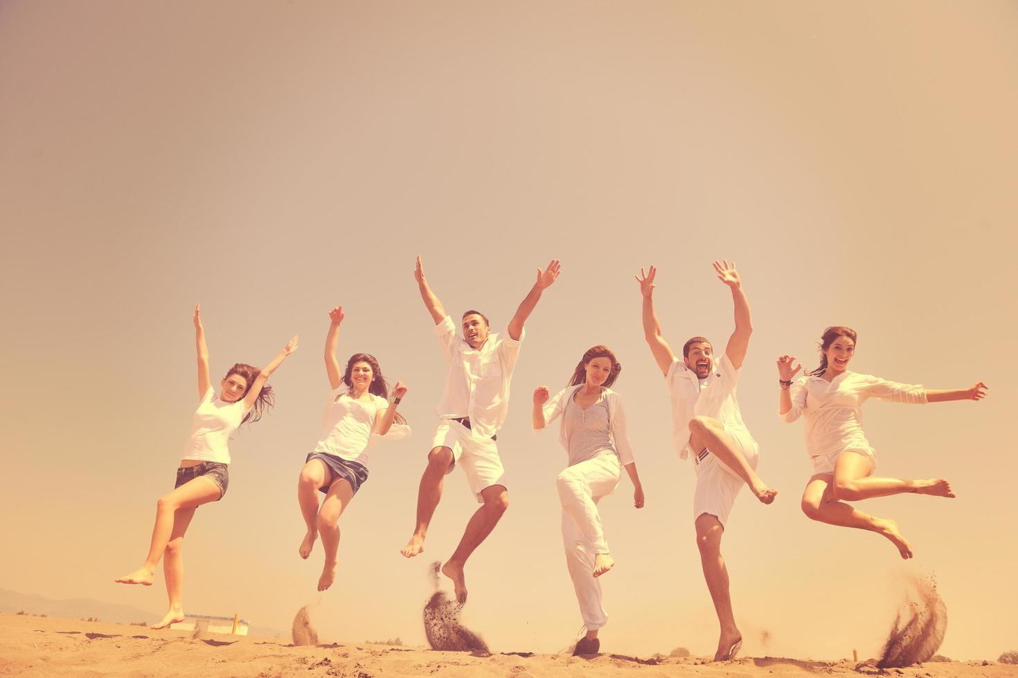 happy people group have fun and running on beach photo