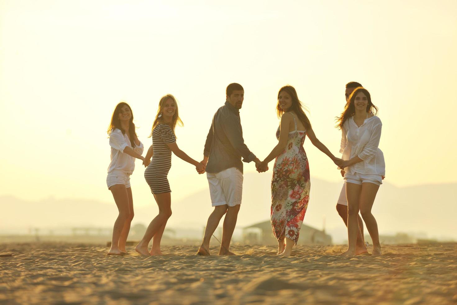 happy young  people group have fun on beach photo