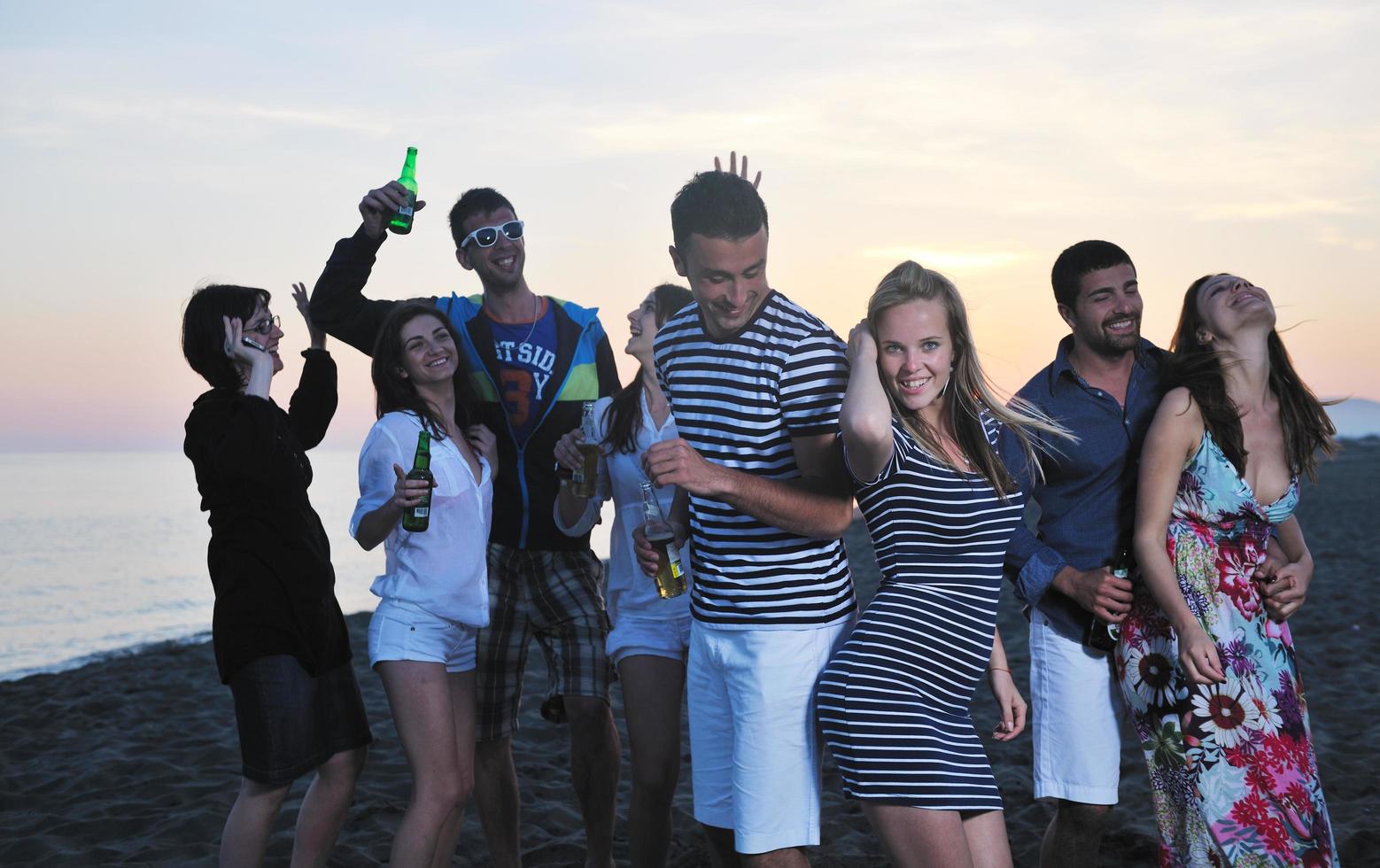 Group of young people enjoy summer  party at the beach photo