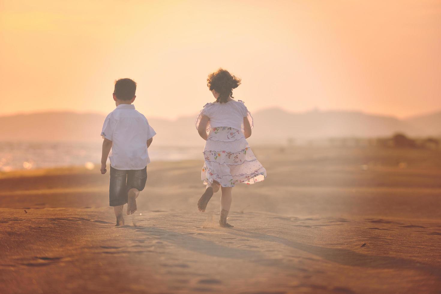 happy young family have fun on beach at sunset photo