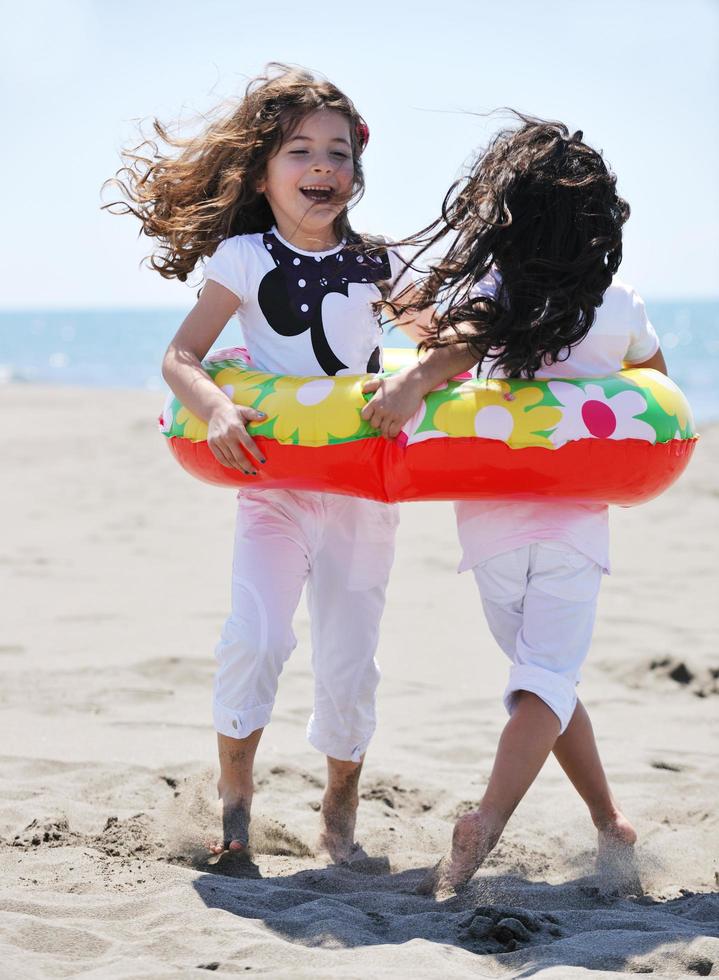 happy child group playing  on beach photo