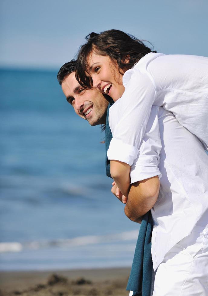 happy young couple have fun at beautiful beach photo