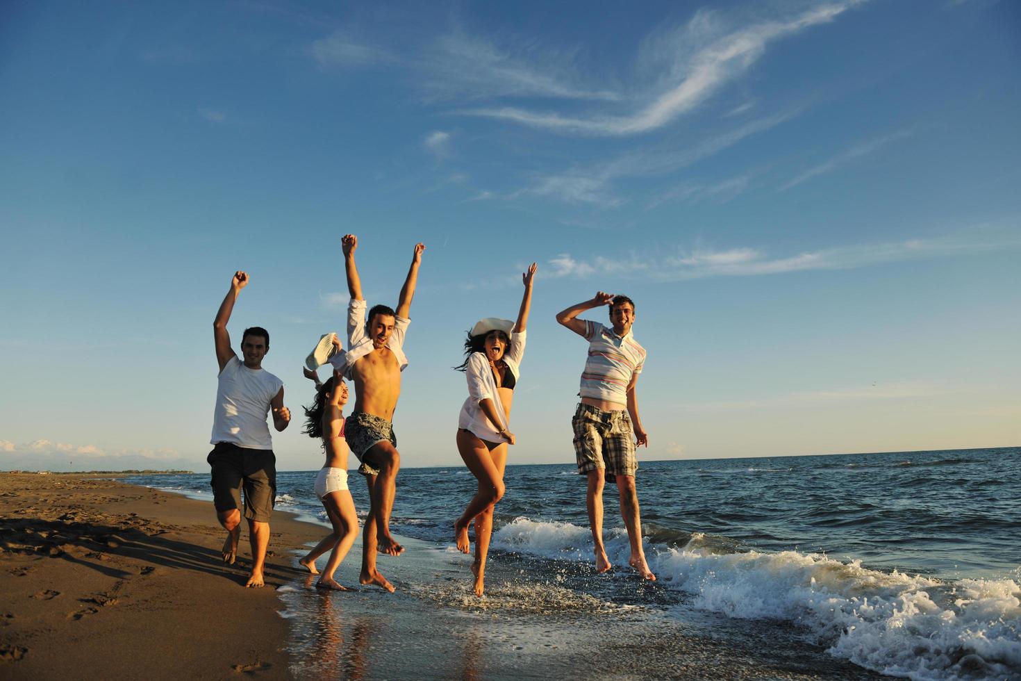 people group running on the beach photo