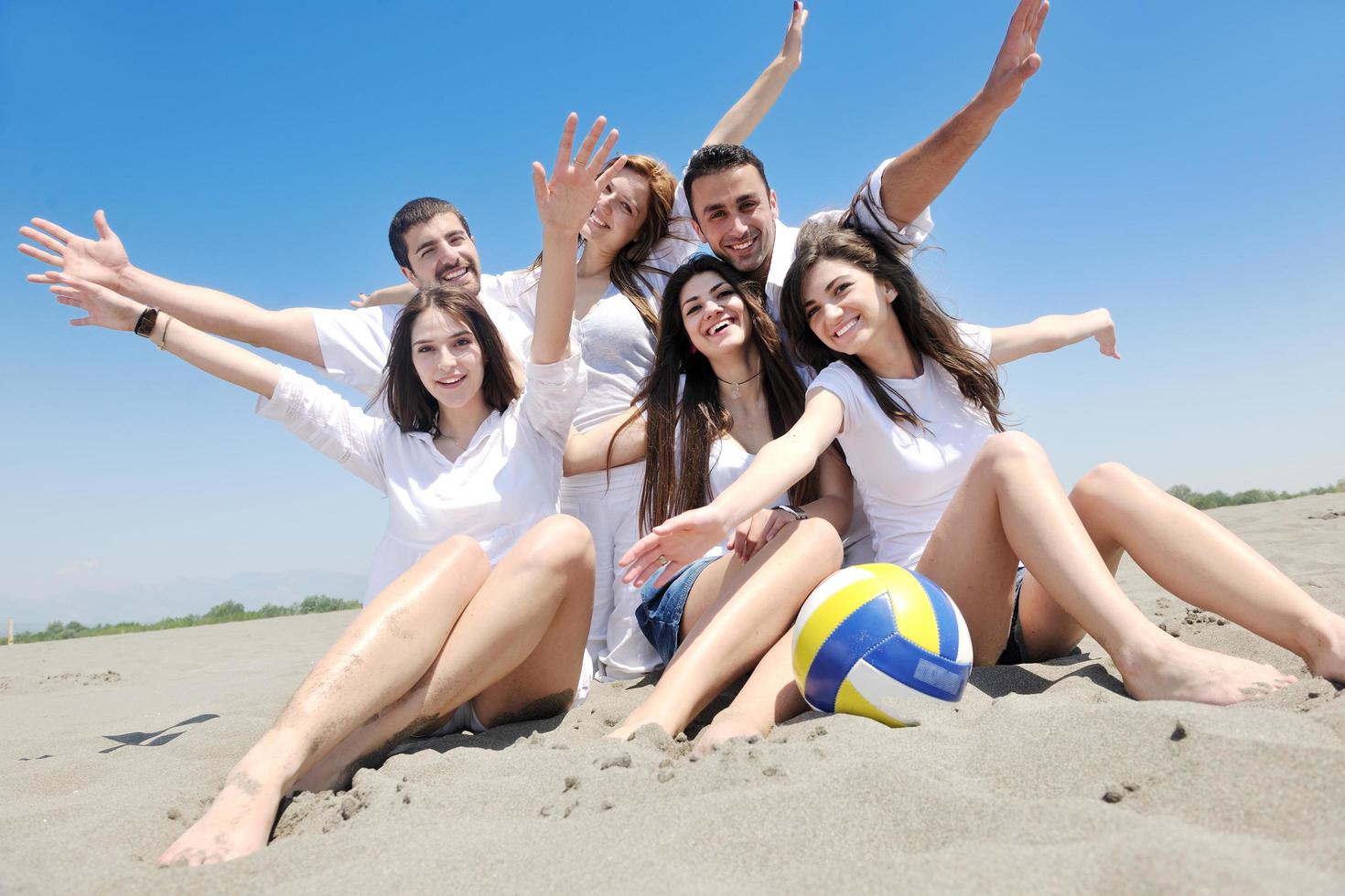 happy young  people group have fun on beach photo