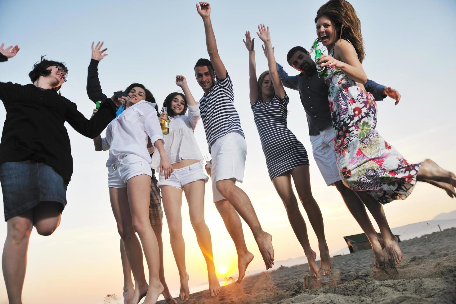 Group of young people enjoy summer  party at the beach photo