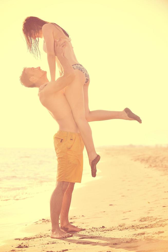 happy young couple have romantic time on beach photo
