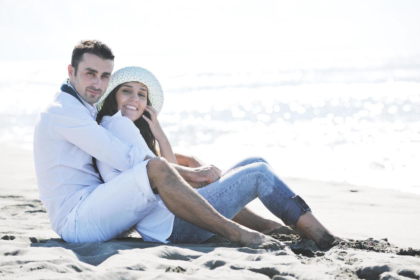 happy young couple have fun at beautiful beach photo