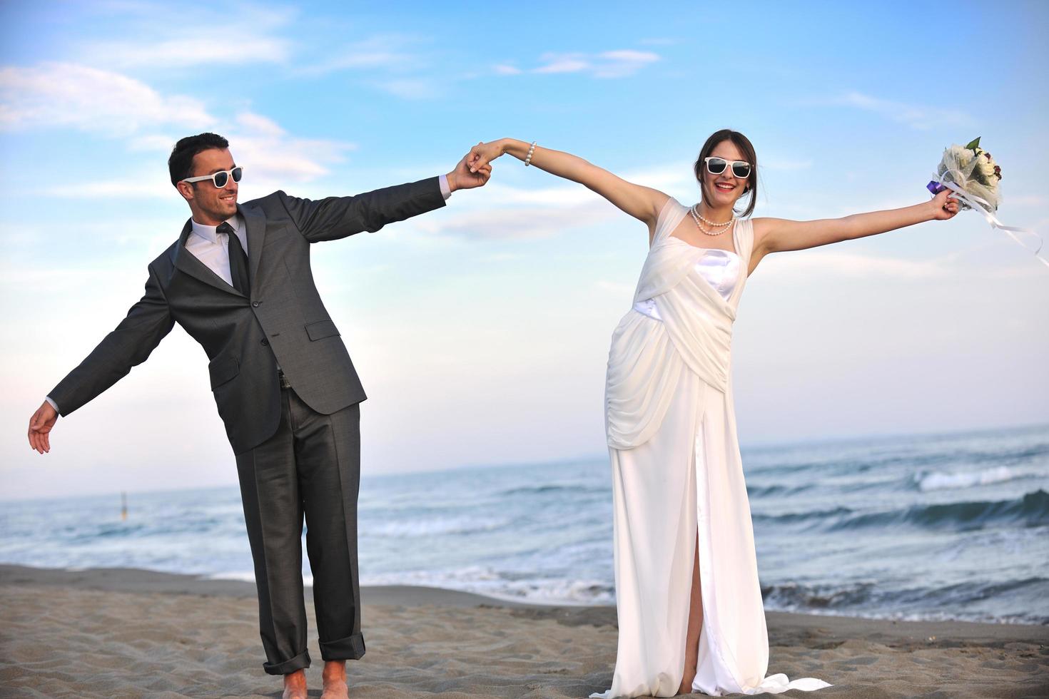 romantic beach wedding at sunset photo