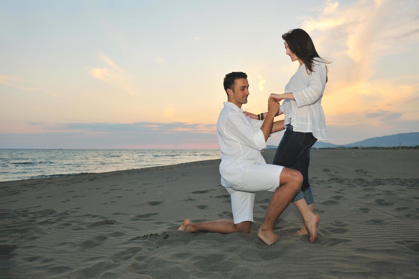 happy young couple have fun on beach photo