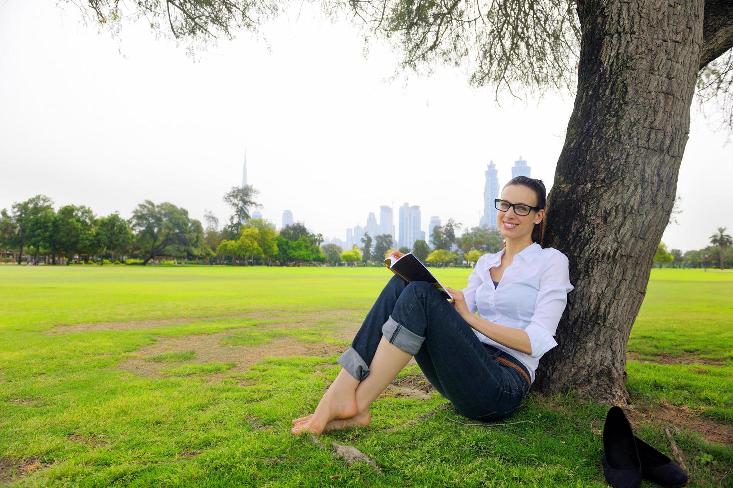 Young woman reading a book in the park photo