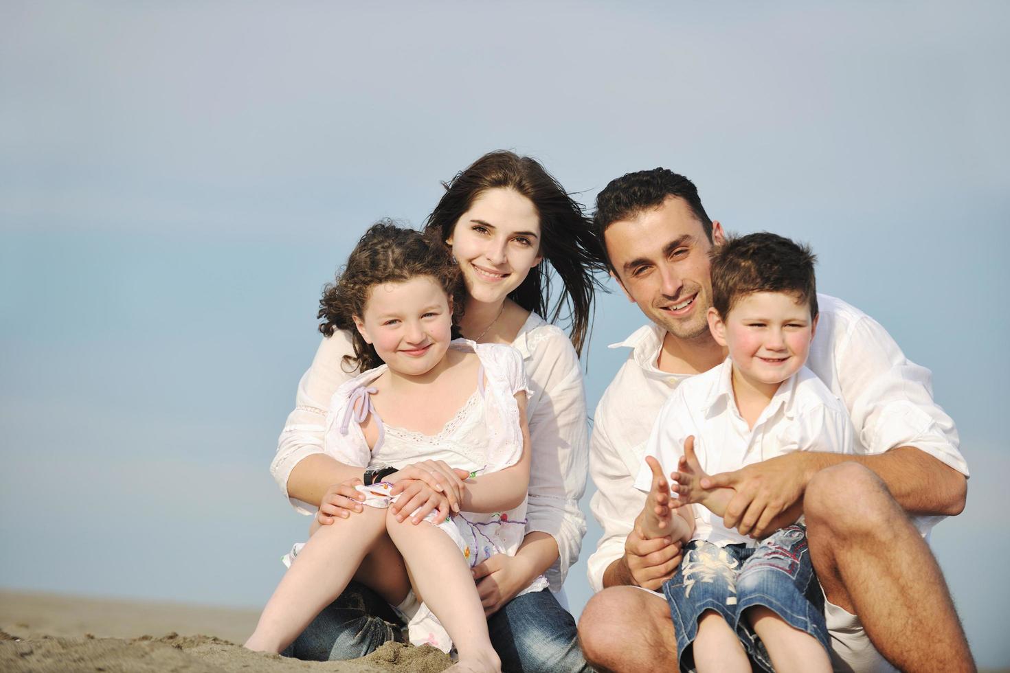 happy young family have fun on beach photo