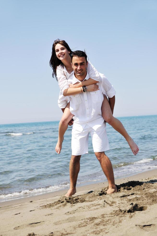 happy young couple have fun on beach photo