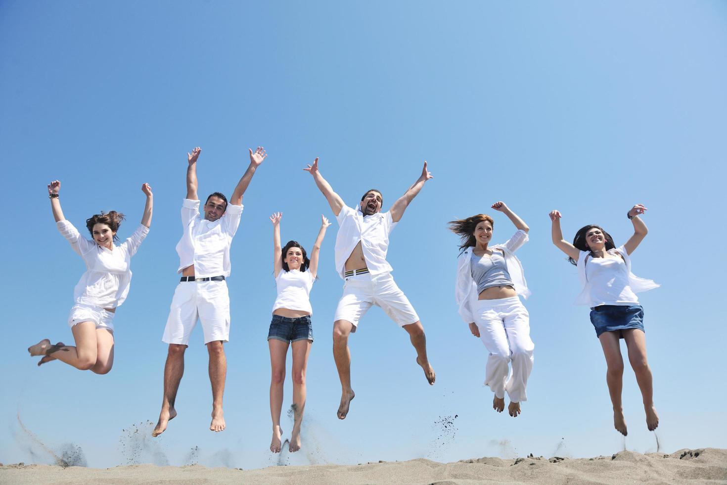 happy people group have fun and running on beach photo