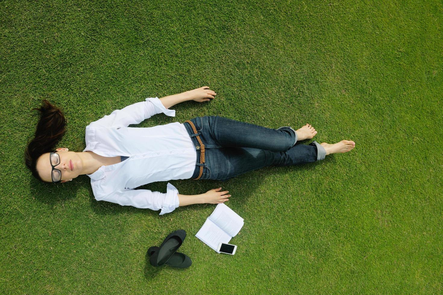 Young woman reading a book in the park photo