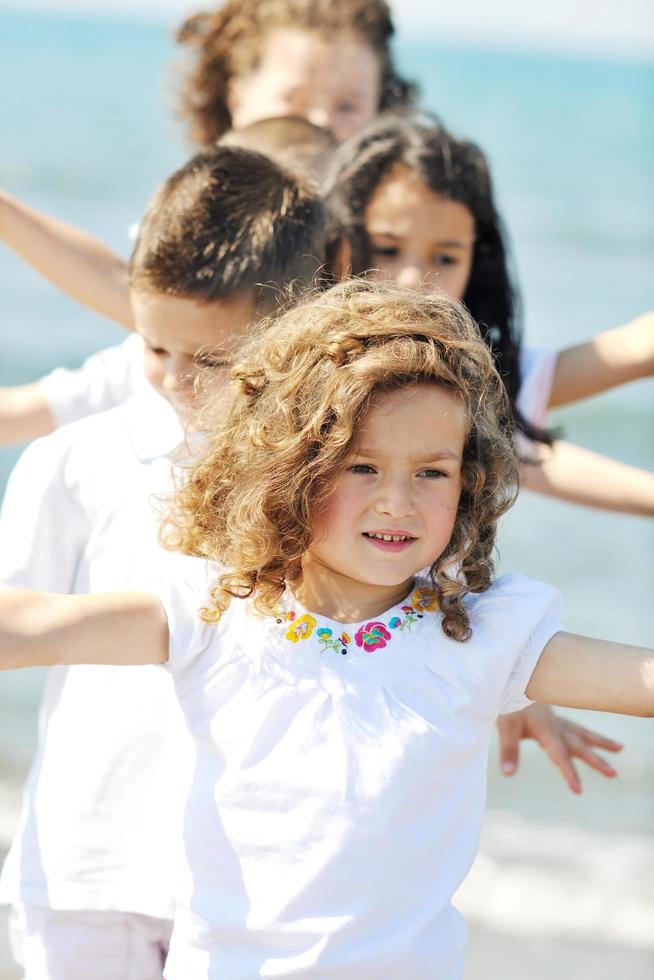 happy child group playing  on beach photo