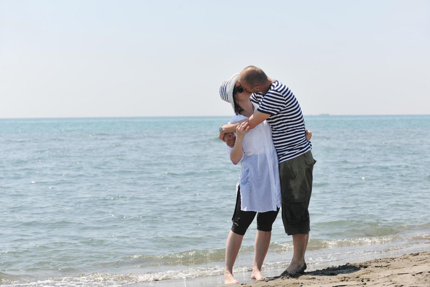 happy young couple have fun on beach photo