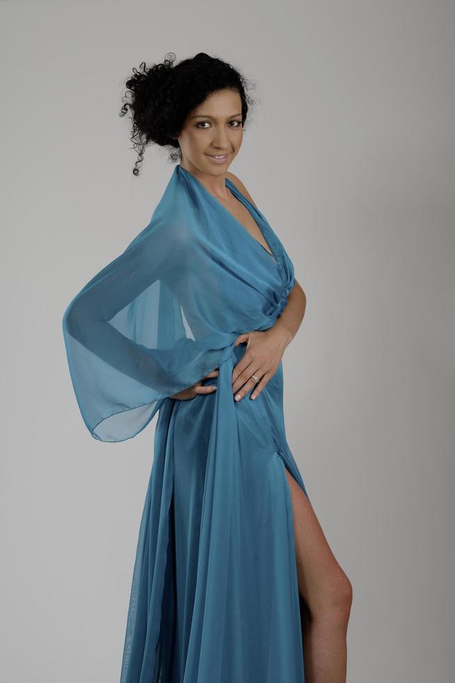 elegant woman in fashionable dress posing in the studio photo