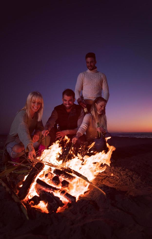 Friends having fun at beach on autumn day photo