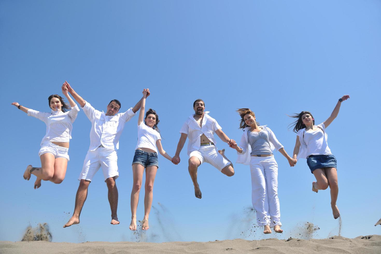 happy people group have fun and running on beach photo