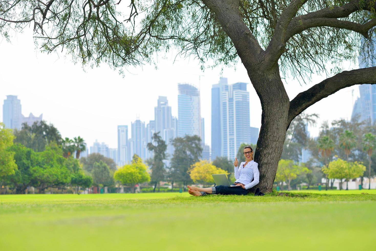 woman with laptop in park photo