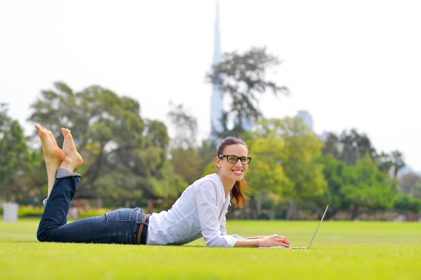 woman with laptop in park photo