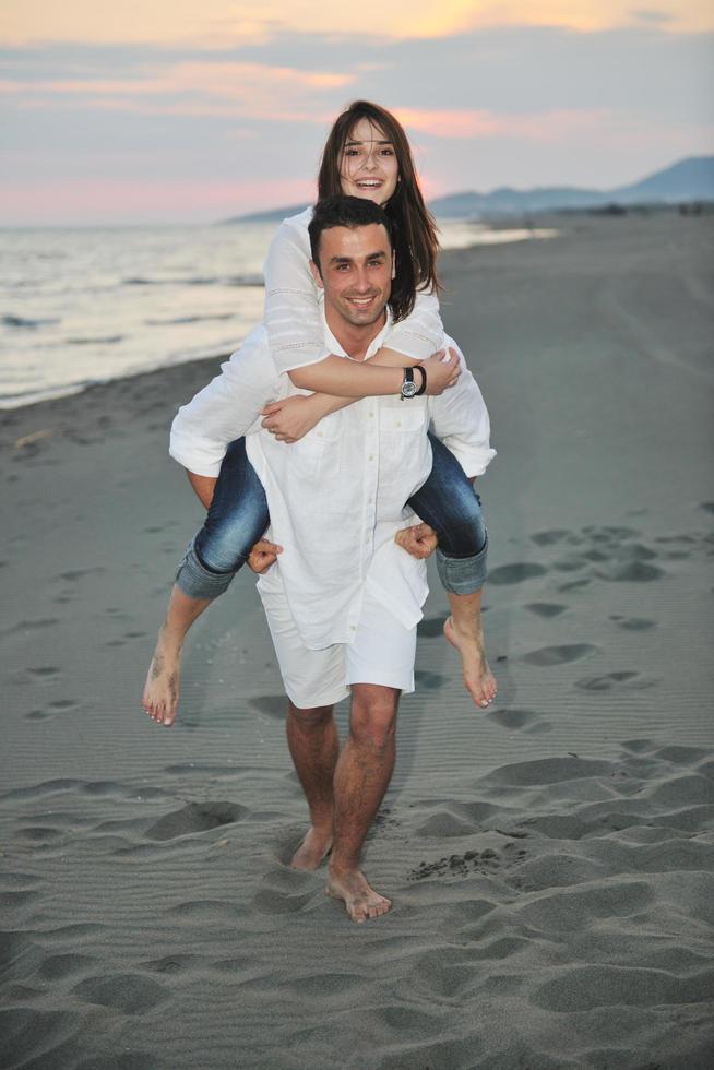 happy young couple have fun on beach photo