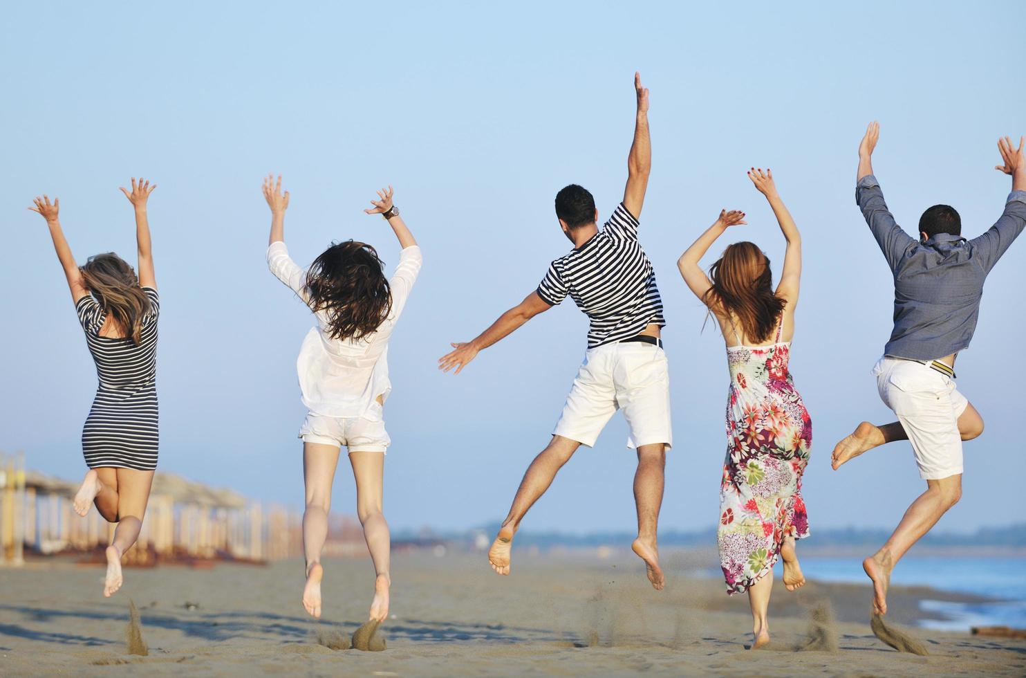 happy young  people group have fun on beach photo