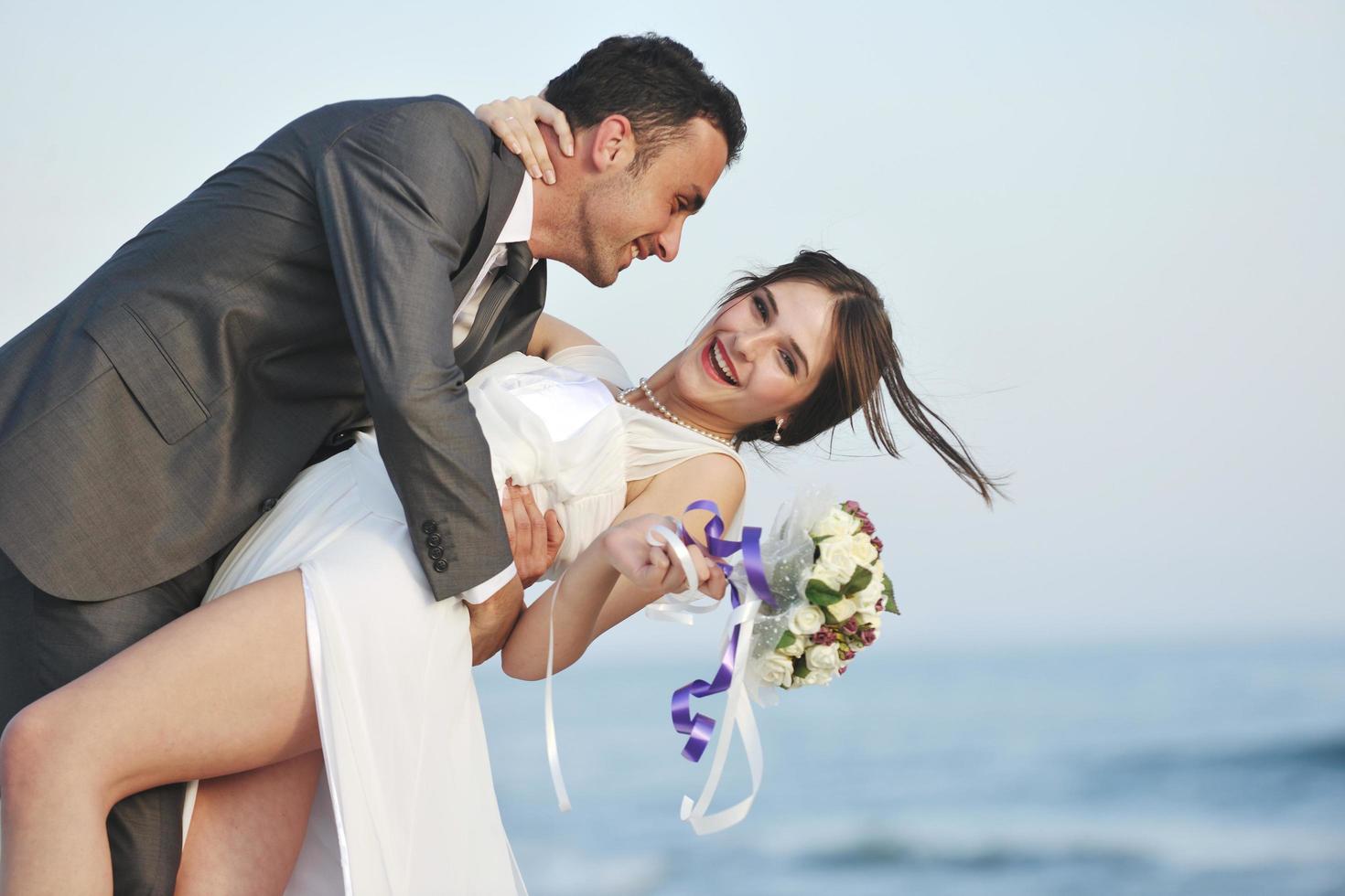 romantic beach wedding at sunset photo