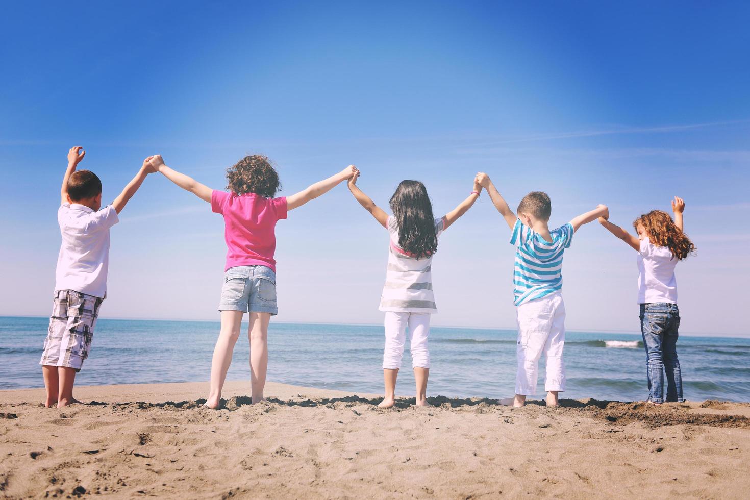 happy young  people group have fun on beach photo