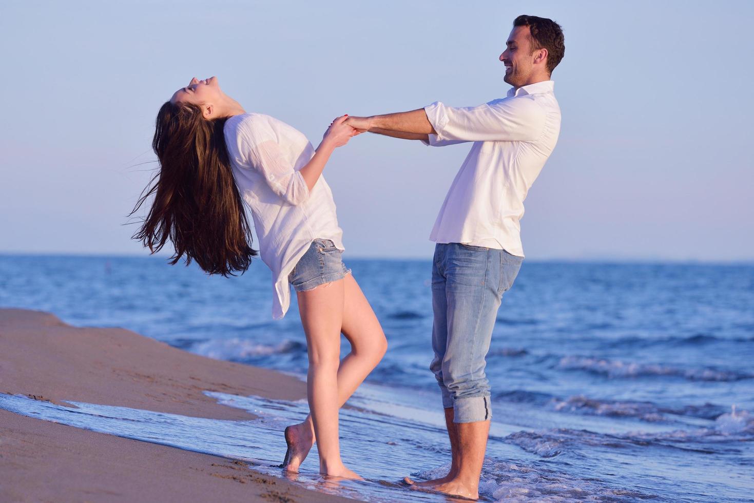 young couple  on beach have fun photo