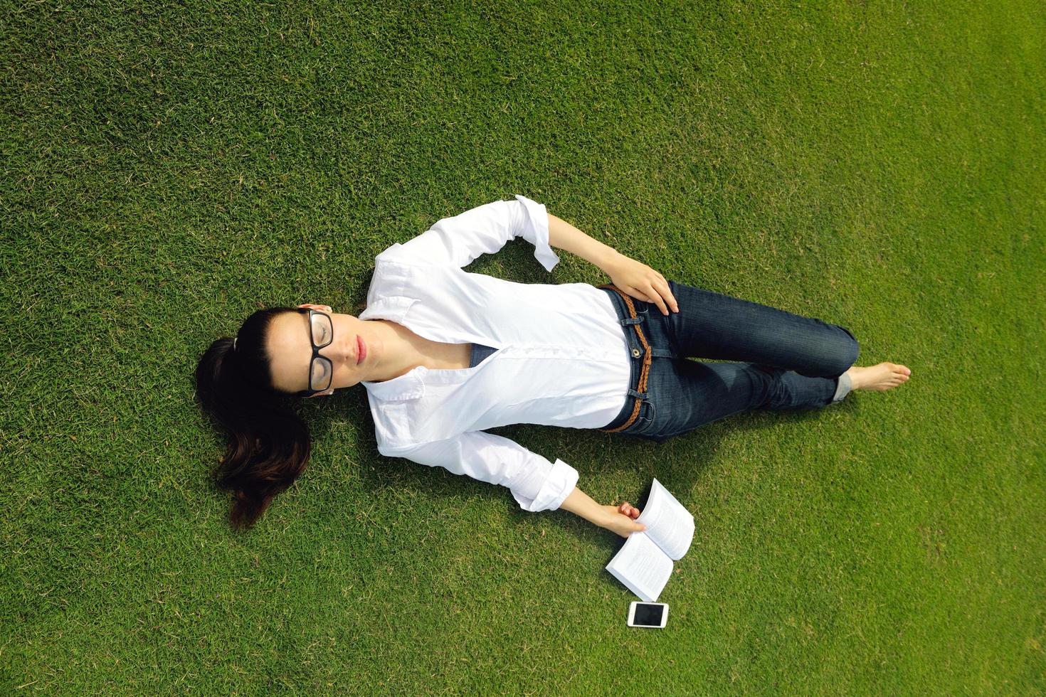 Young woman reading a book in the park photo