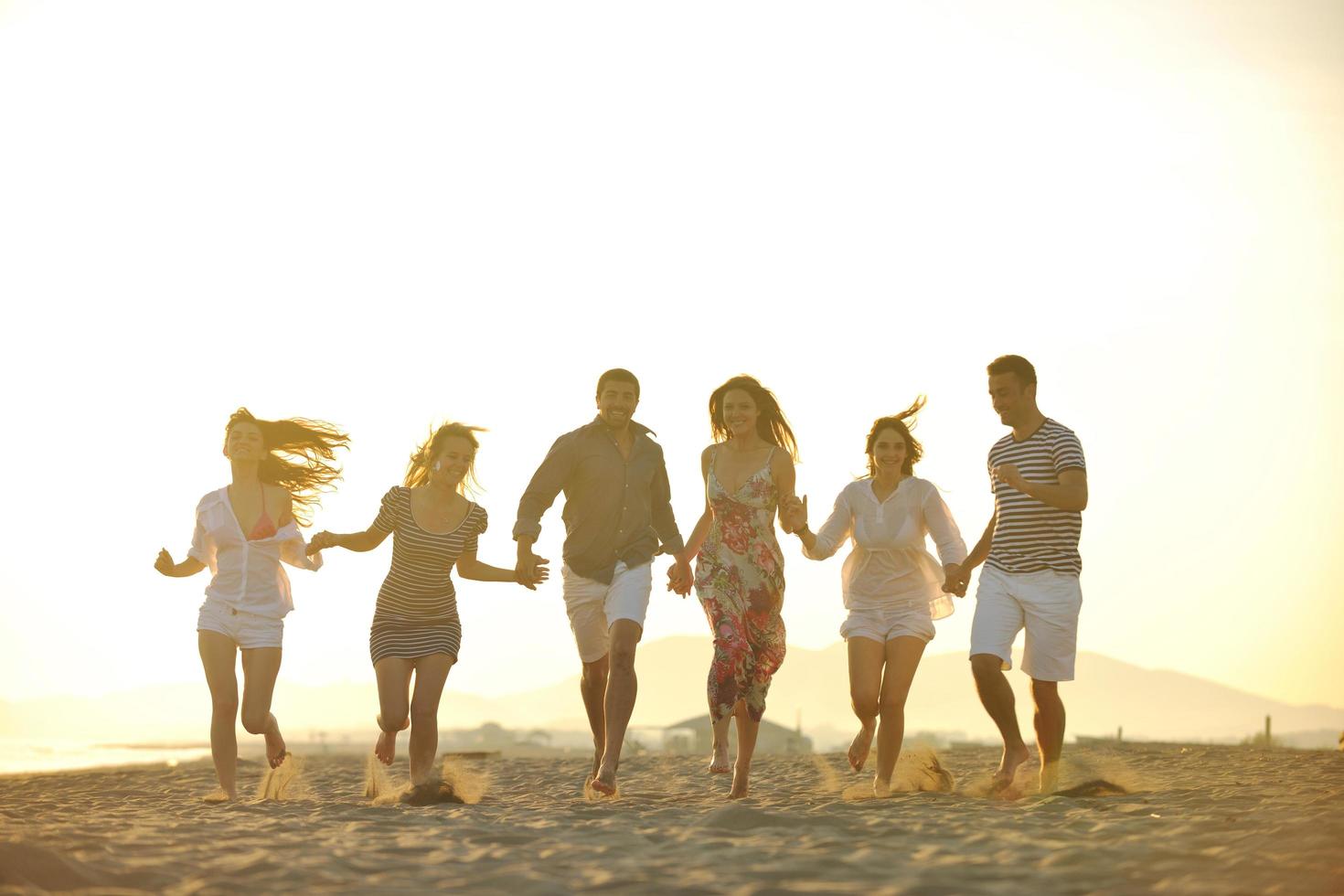 happy young  people group have fun on beach photo