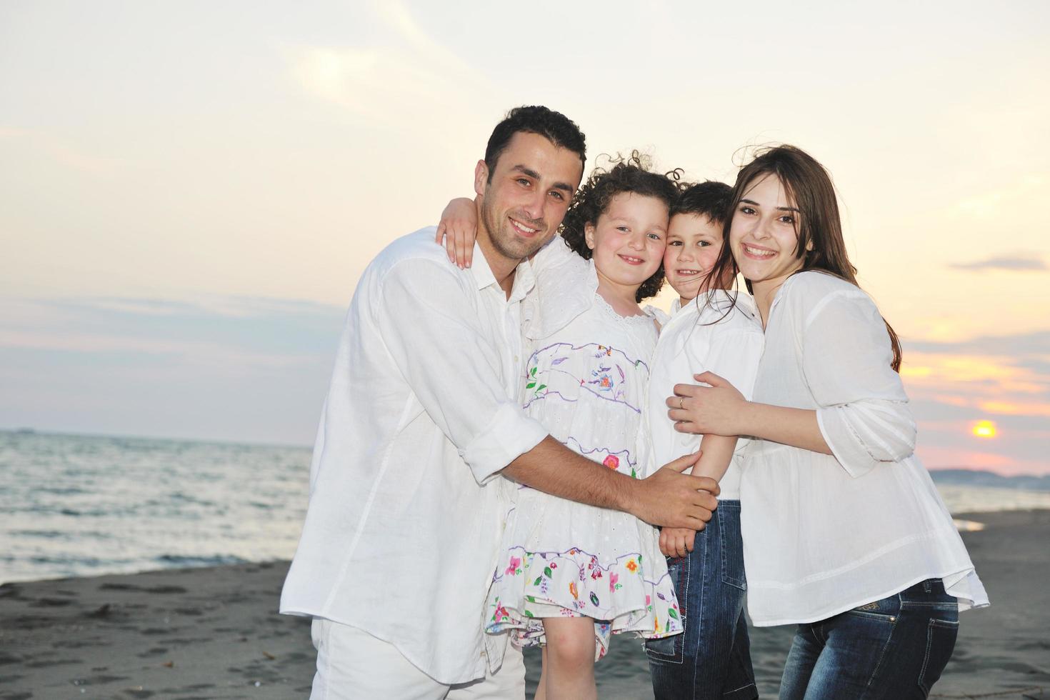 happy young family have fun on beach photo